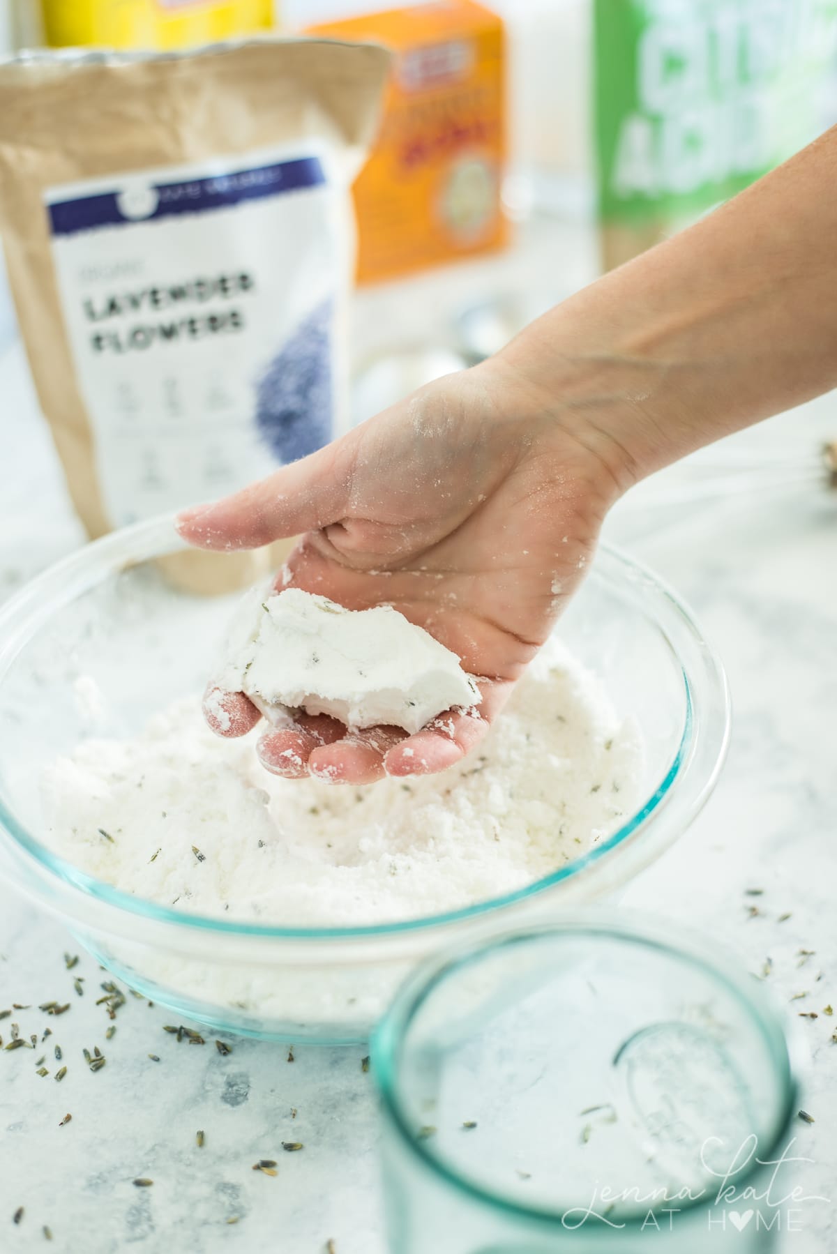 Holding a small amount of the finished mixture in your hands to show the right consistency - damp, not wet or crumbly.