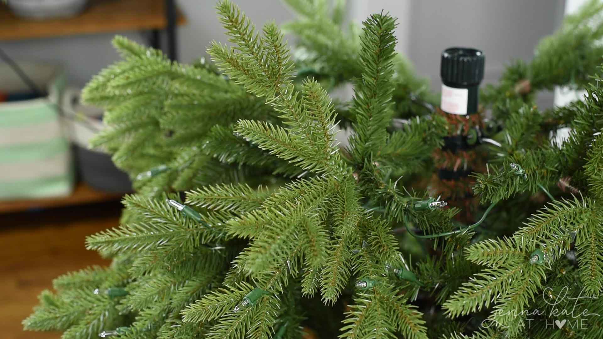 branches of artificial christmas tree being fluffed.