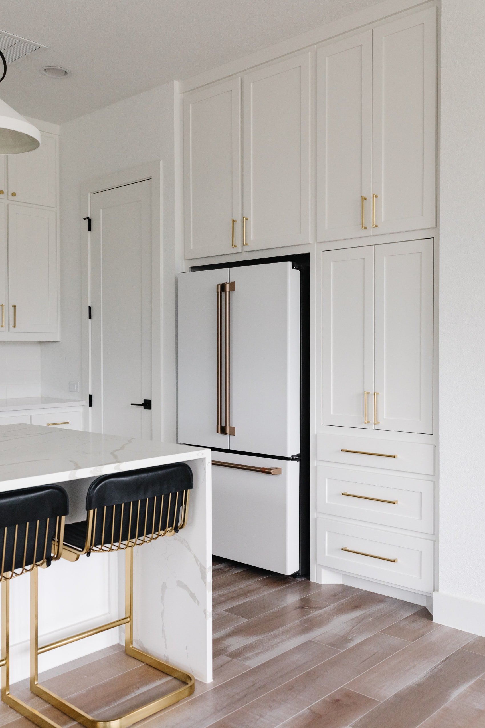 White kitchen cabinets with gold bar pulls
