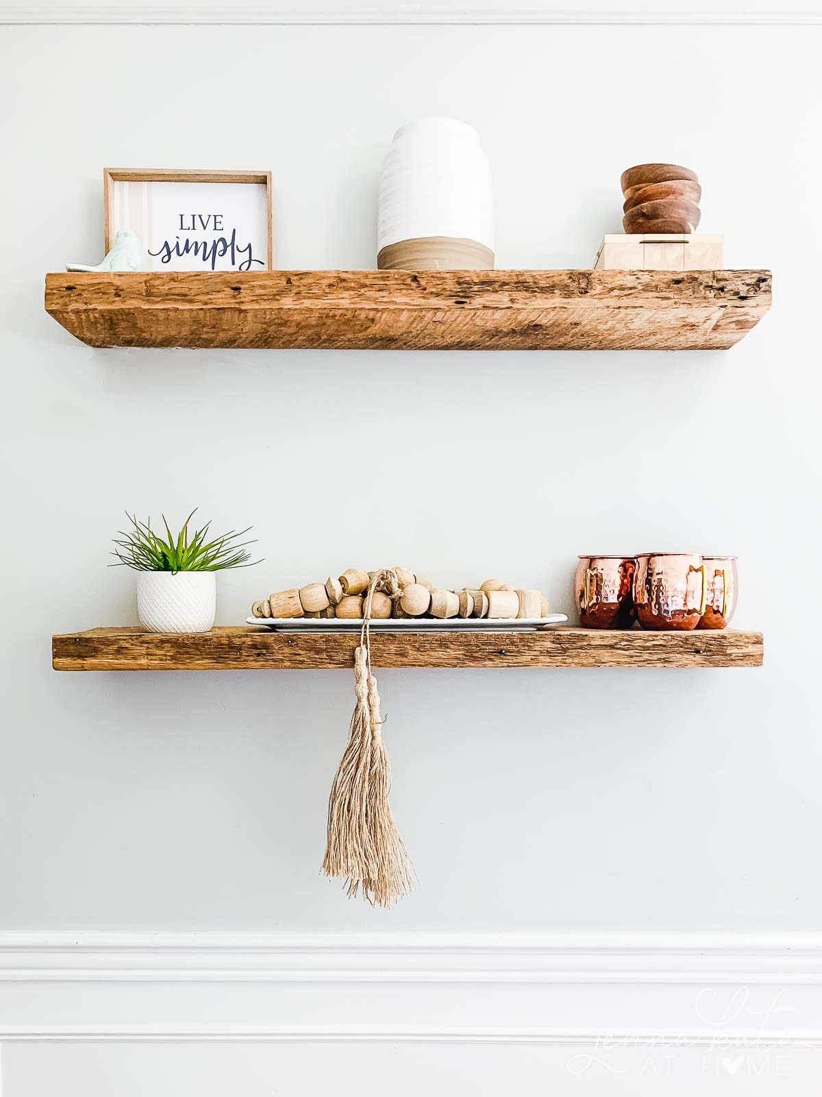 Copper mugs on kitchen shelves decorated for fall