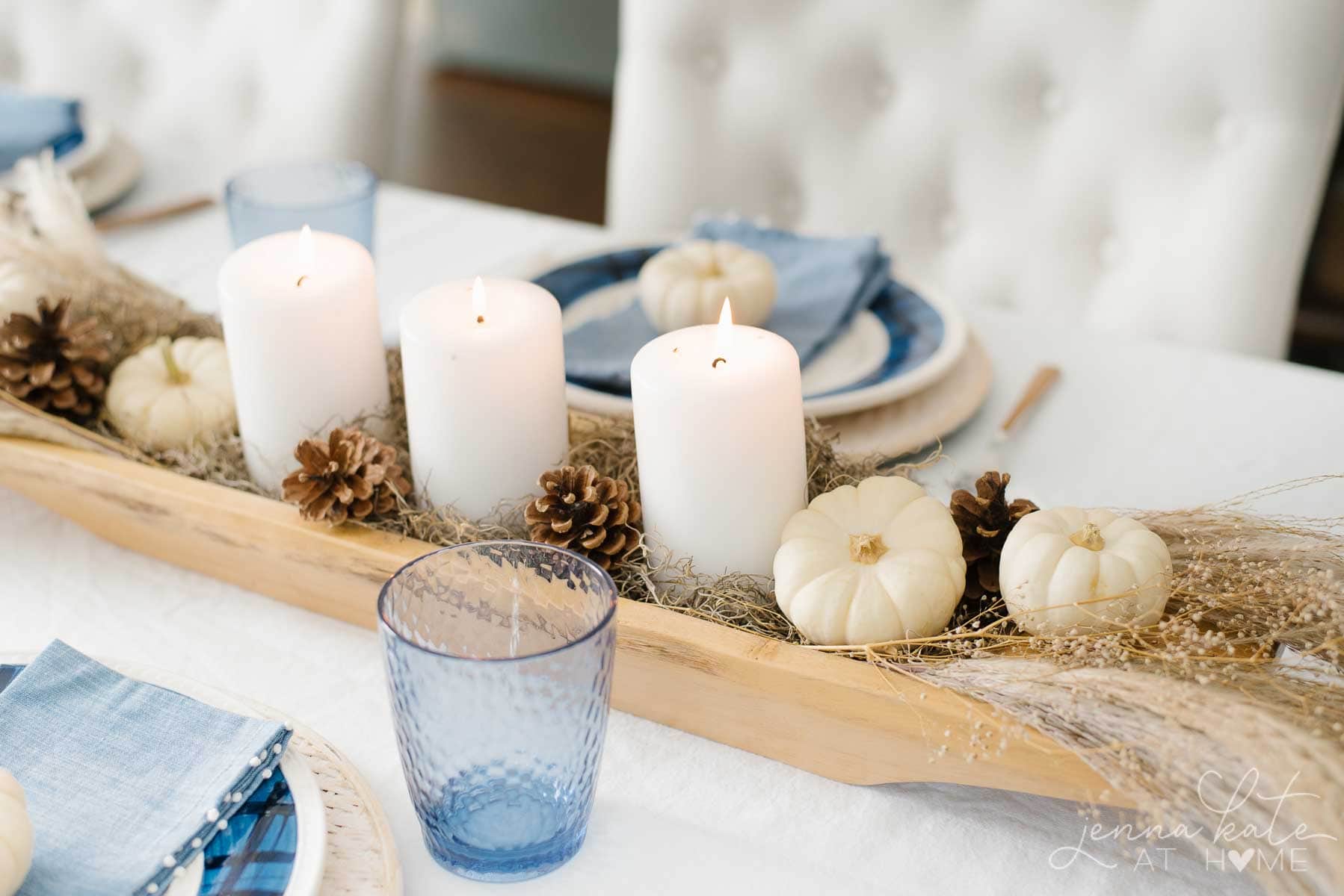 Dough bowl filled with candles, moss and miniature pumpkins