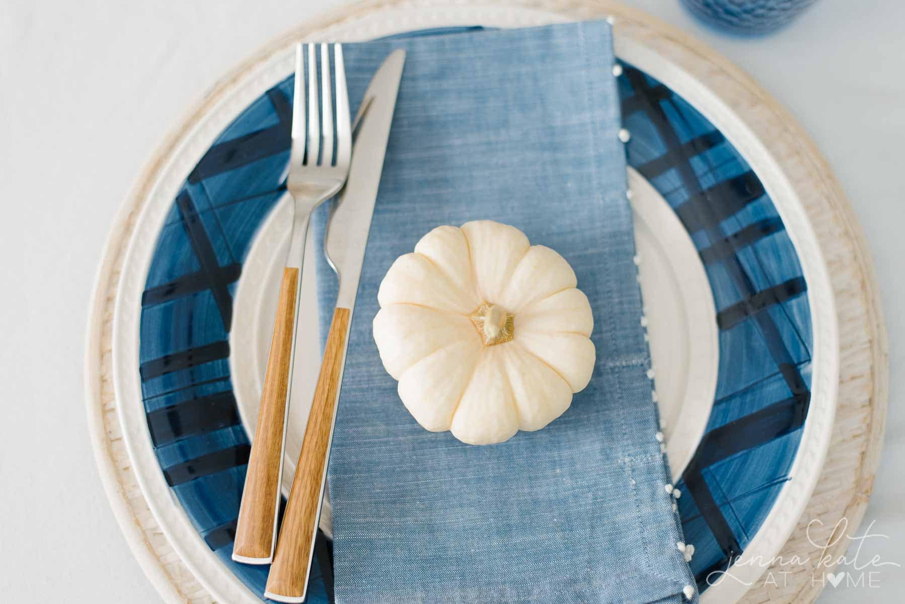mini white pumpkin on a plate as part of a table setting inspired by nature