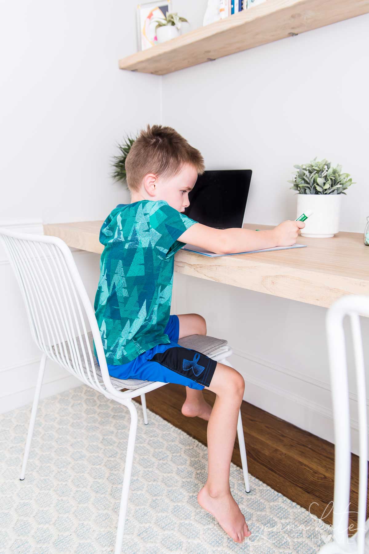 Young boy sitting at a desk during  for homeschool or remote learning