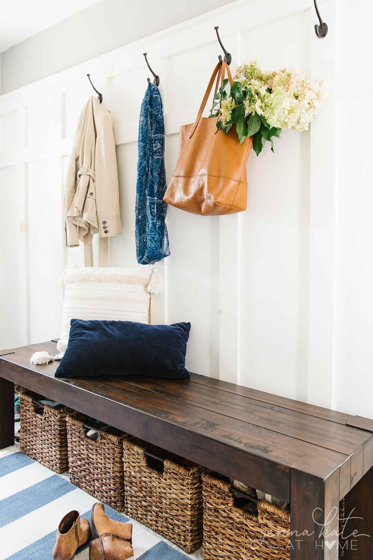 Mudroom simply decorated for fall with a tote bag filled with hydrangeas
