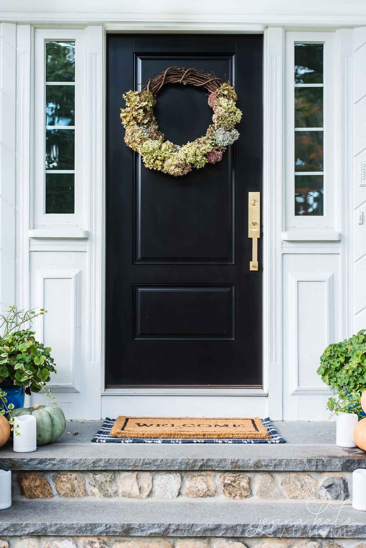 black front door with hydrangea wreath for fall