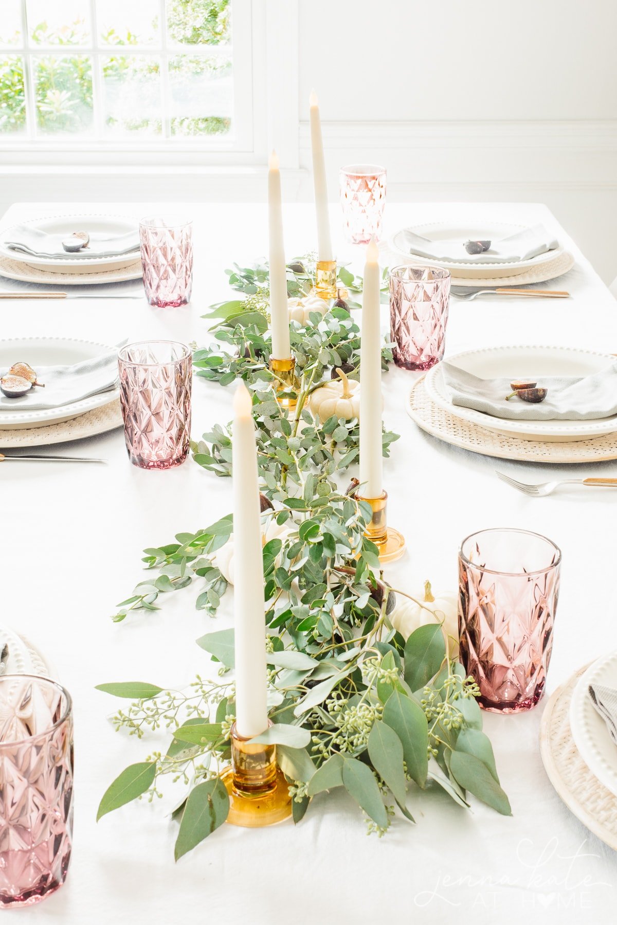 fall themed tablescape with eucalyptus draped down the center of the table