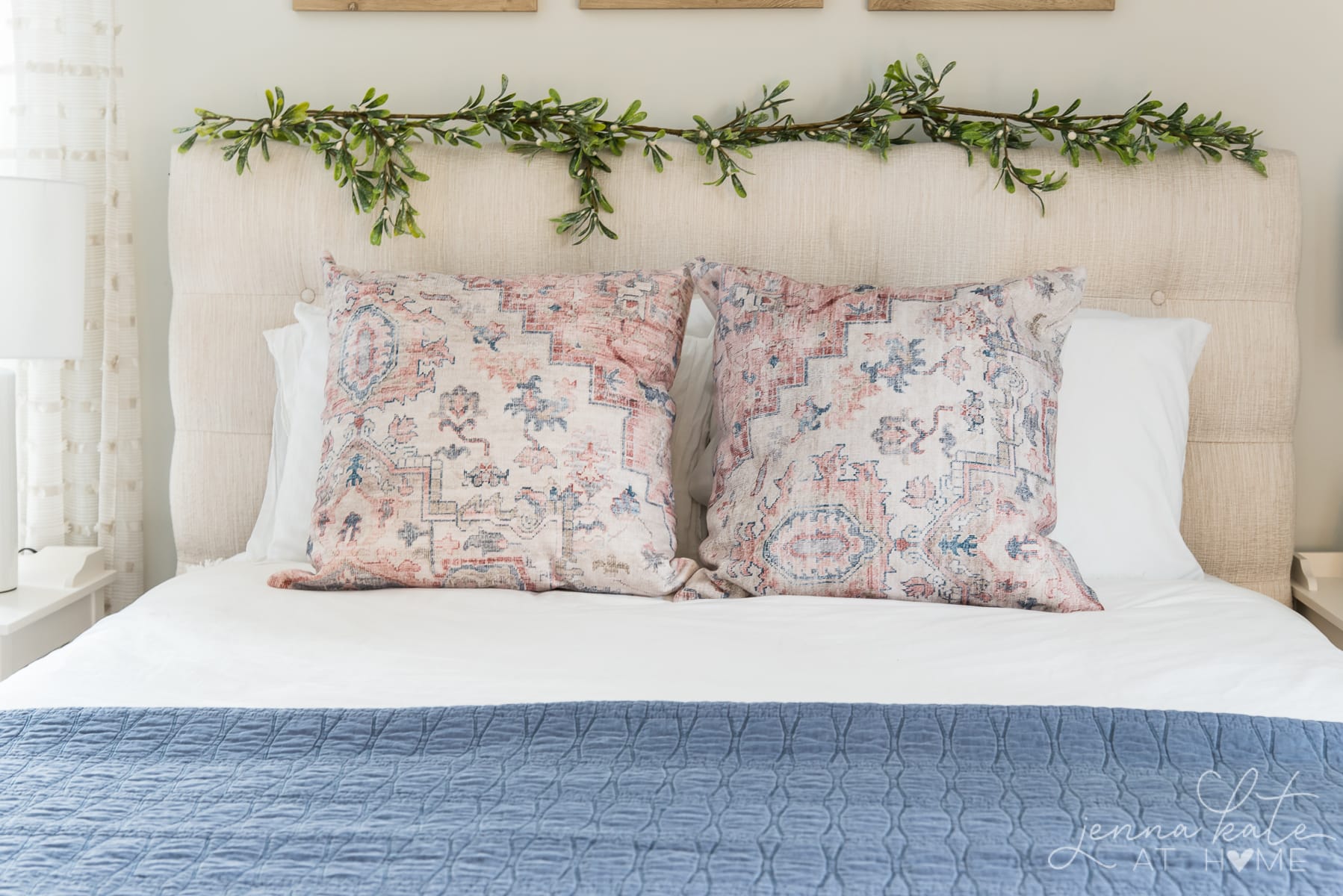 Be with white sheets and touches of blue and pink decor