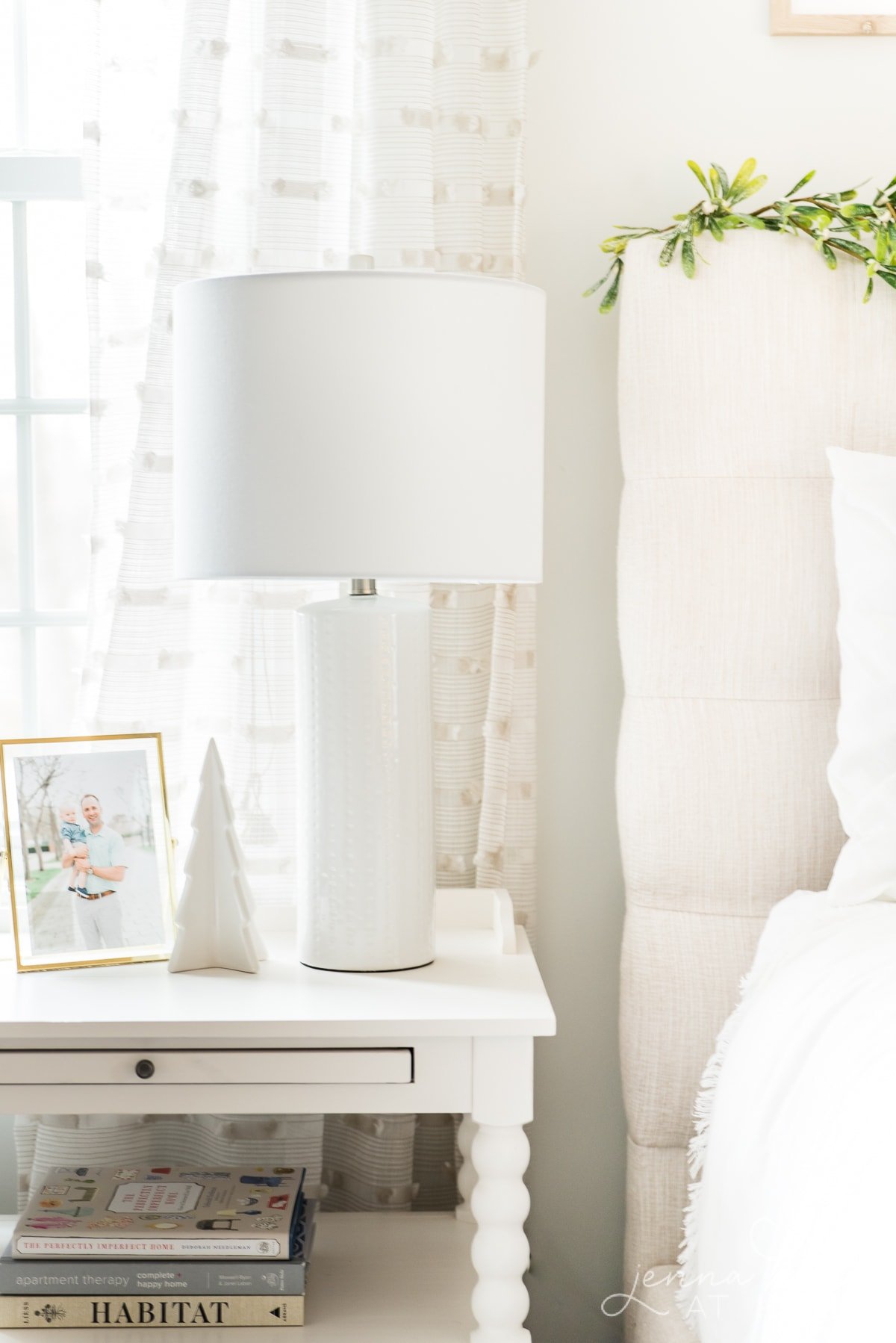 Simple white ceramic Christmas tree on the nightstand