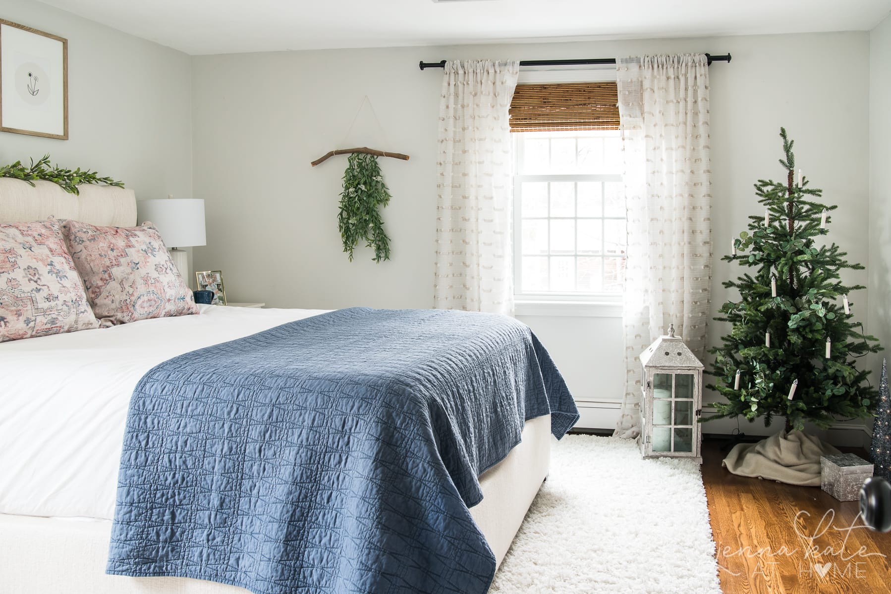 bedroom with small Christmas tree in the corner