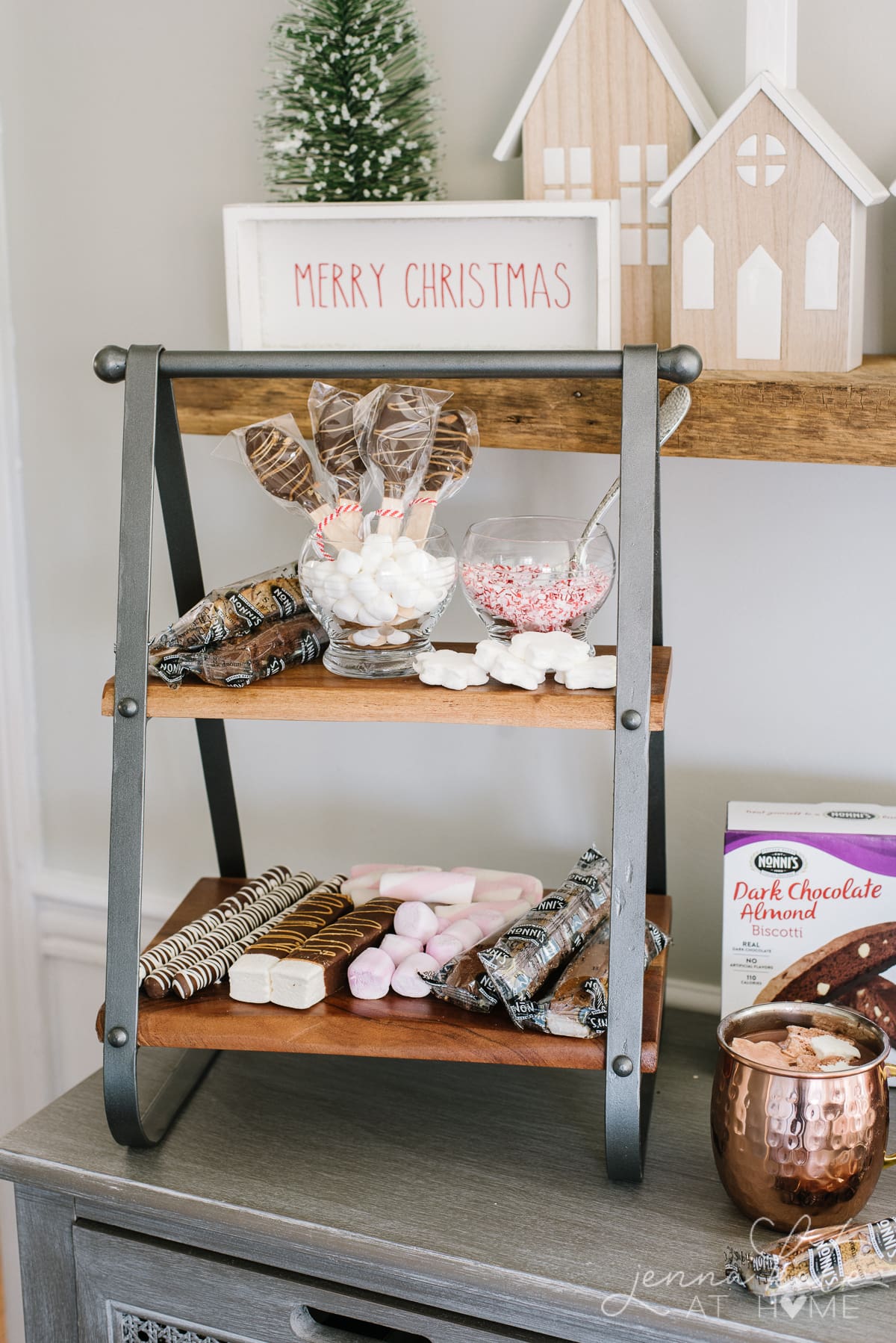 Tiered stand filled with marshmallows, chocolate stir spoons and other hot cocoa accompiments
