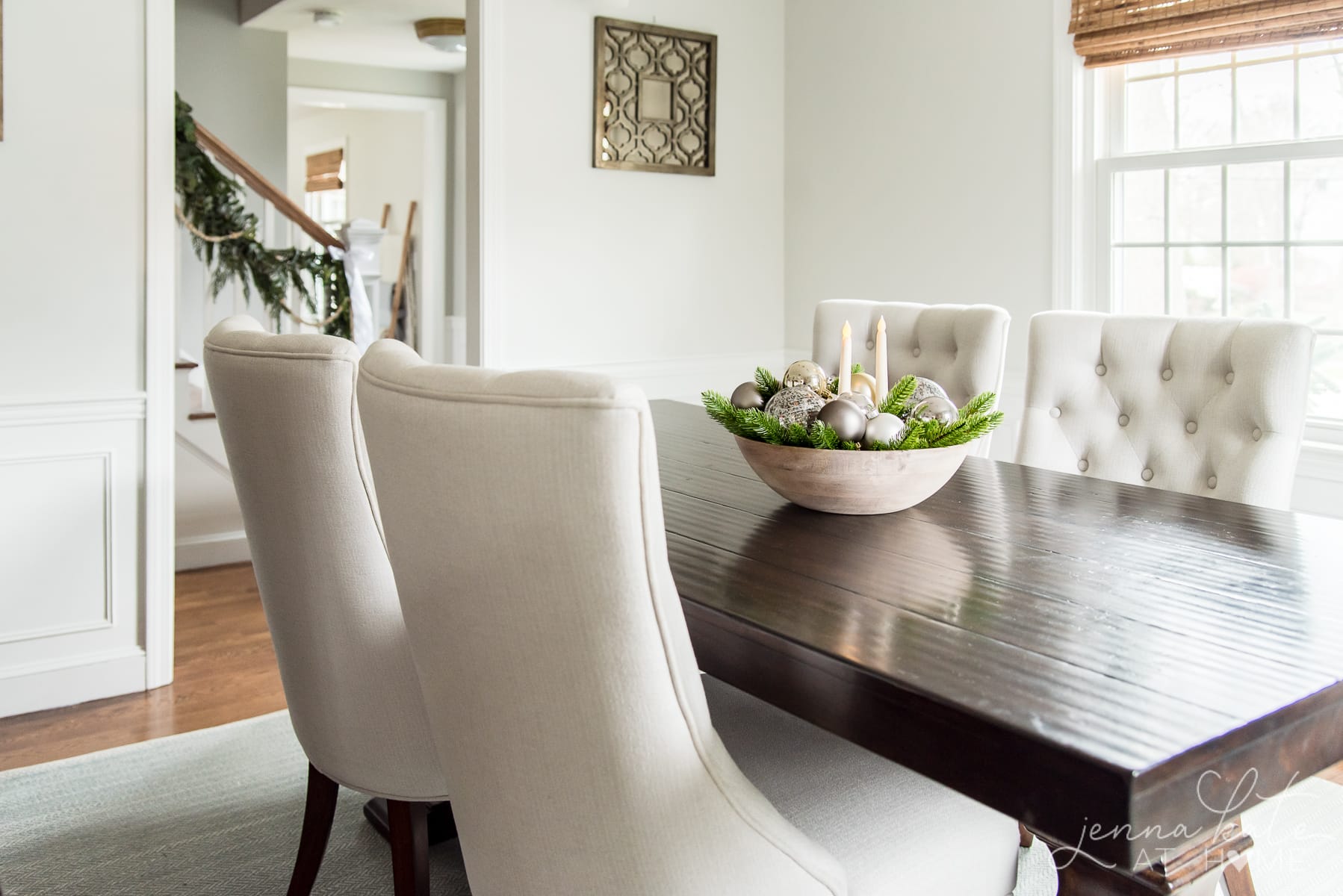 A living room filled with furniture and Christmas centerpiece on a table