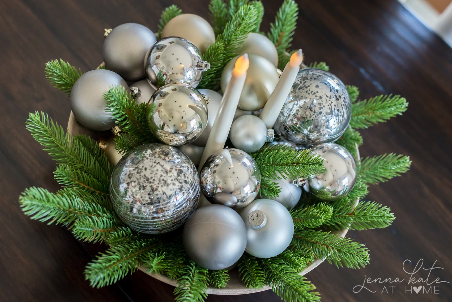 bowl of Christmas ornaments and evergreens