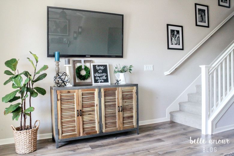 A living room filled with furniture and a fireplace with walls painted sherwin williams wordly gray