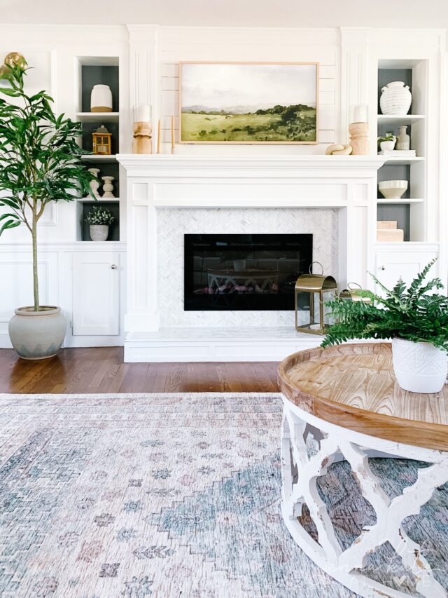 living room with frame tv over the mantel