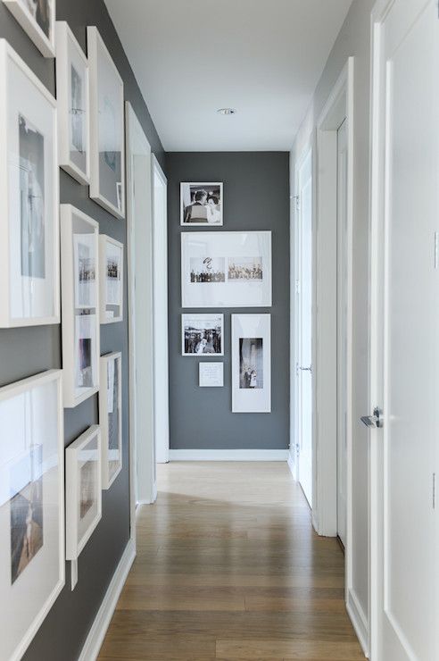 Hallway with Kendall Charcoal walls and bright white trim and photo frames