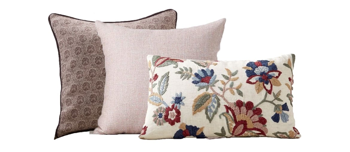 the same floral pillow paired with pink toned pillows