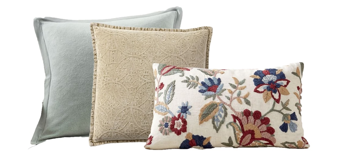 the floral lumbar pillow now paired with one green and one golden hued pillow