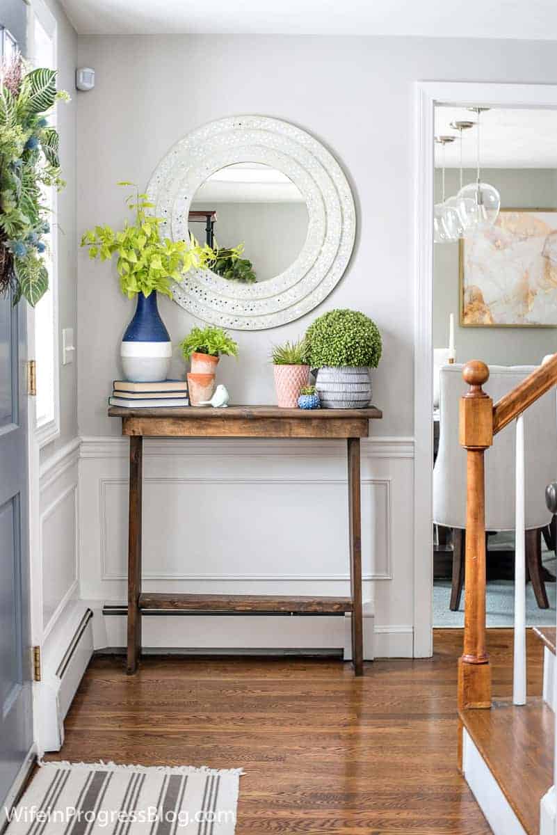 Repose Gray entryway with white wainscoting and wooden console table