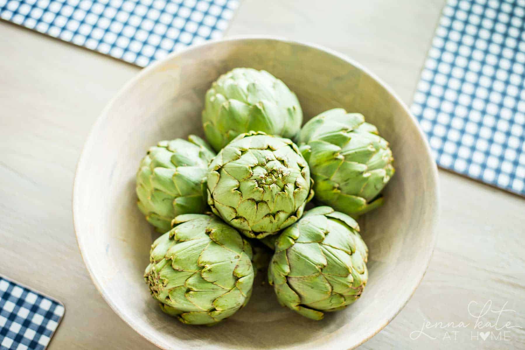 a bowl full of fresh artichokes as a spring table centerpiece 