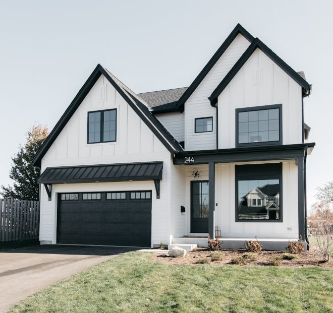 White farmhouse with painted with Iron Ore trim