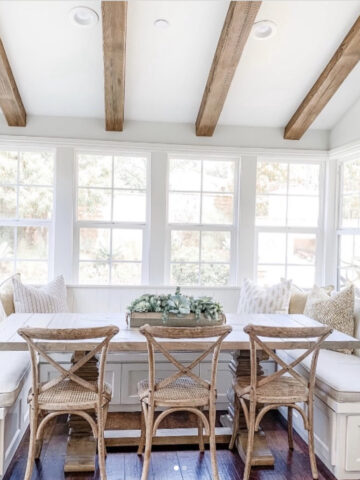 Kitchen breakfast nook with a large window and ceiling beams