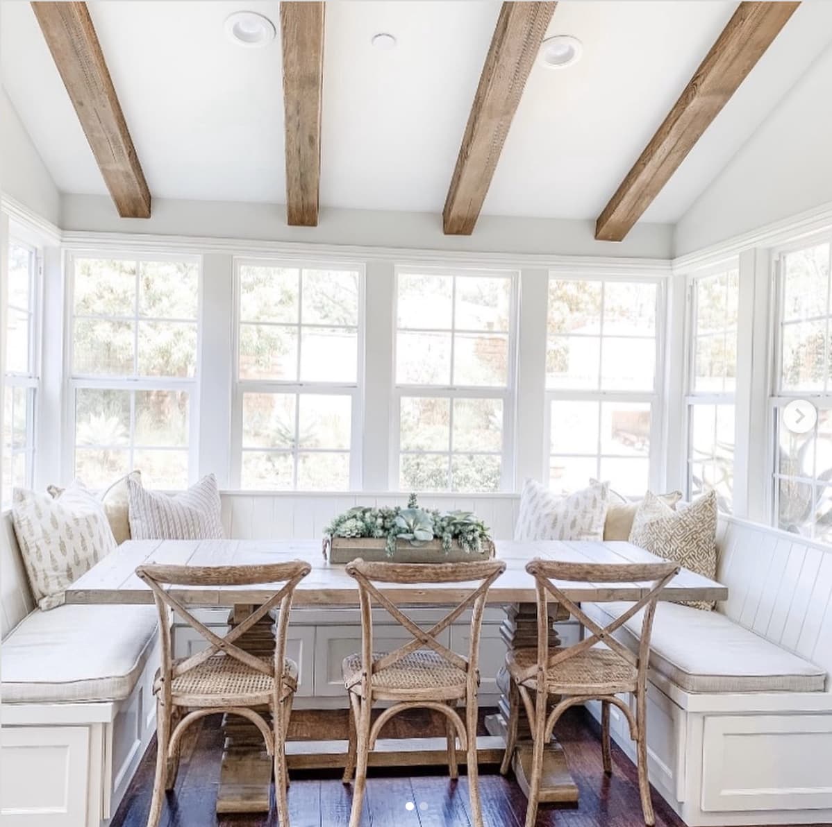 Kitchen breakfast nook with a large window and ceiling beams