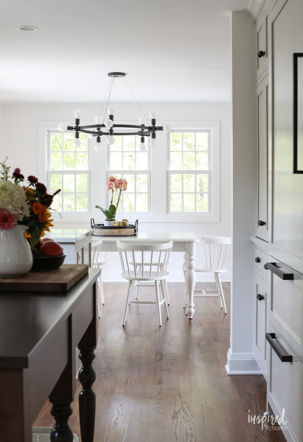 view of a white dining room set seen through a kitchen