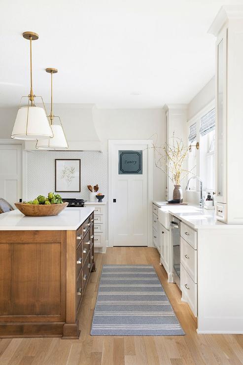 traditional white kitchen with medium wood tone island