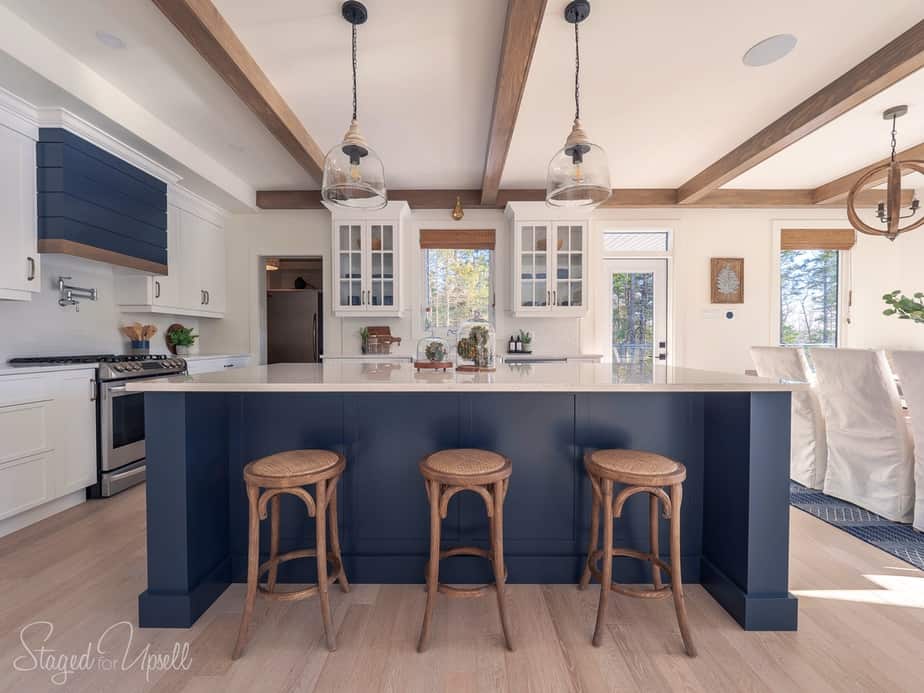 navy blue kitchen island with rustic wood beams overheard