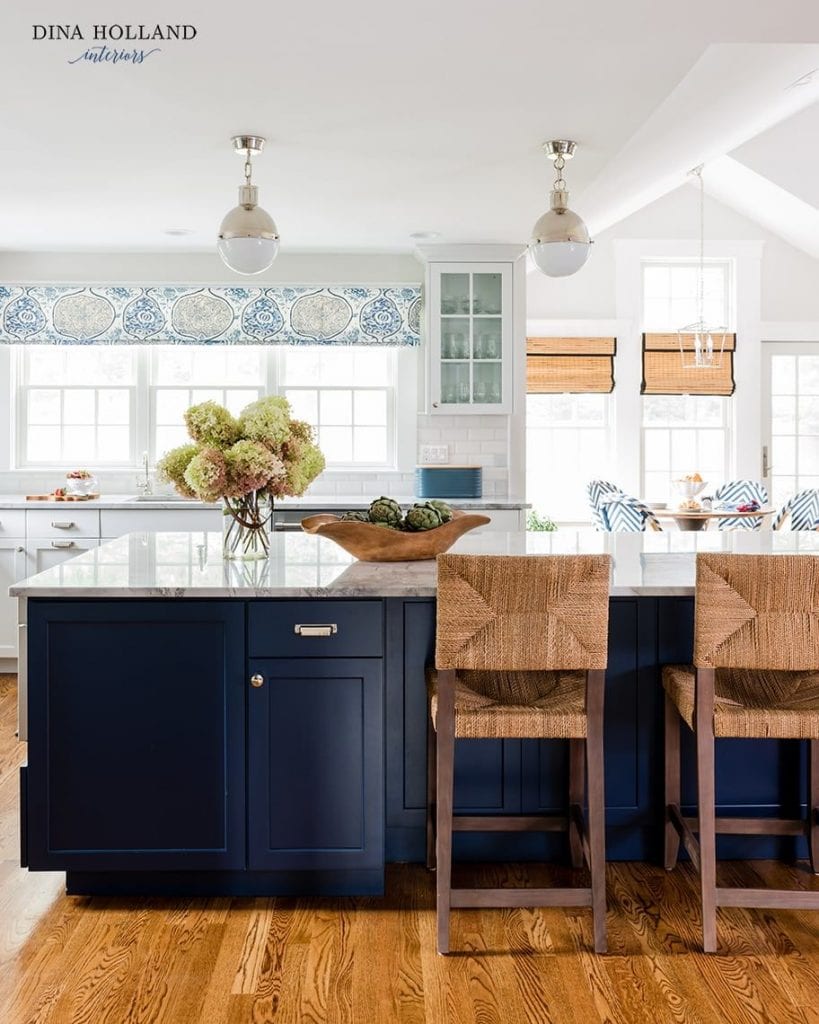 bright white kitchen with navy blue island