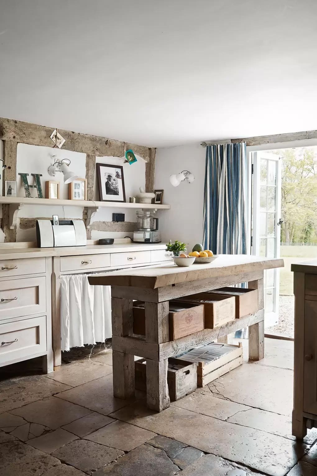 European farmhouse style kitchen with reclaimed wood floating island