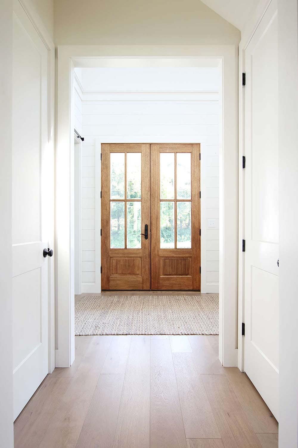 sherwin williams creamy entryway with wooden french doors