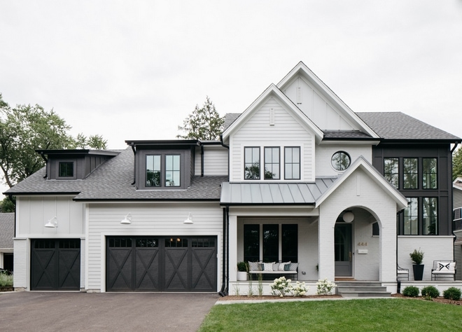 farmhouse style home with siding painted passive with black accents