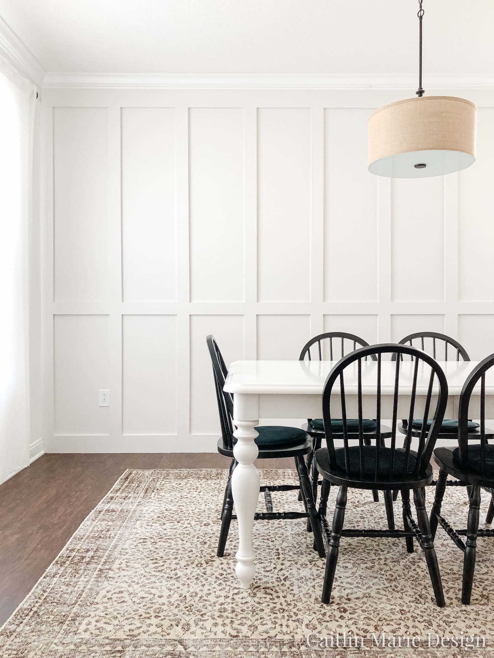 Dining space with beefy floor to ceiling board and batten accent wall