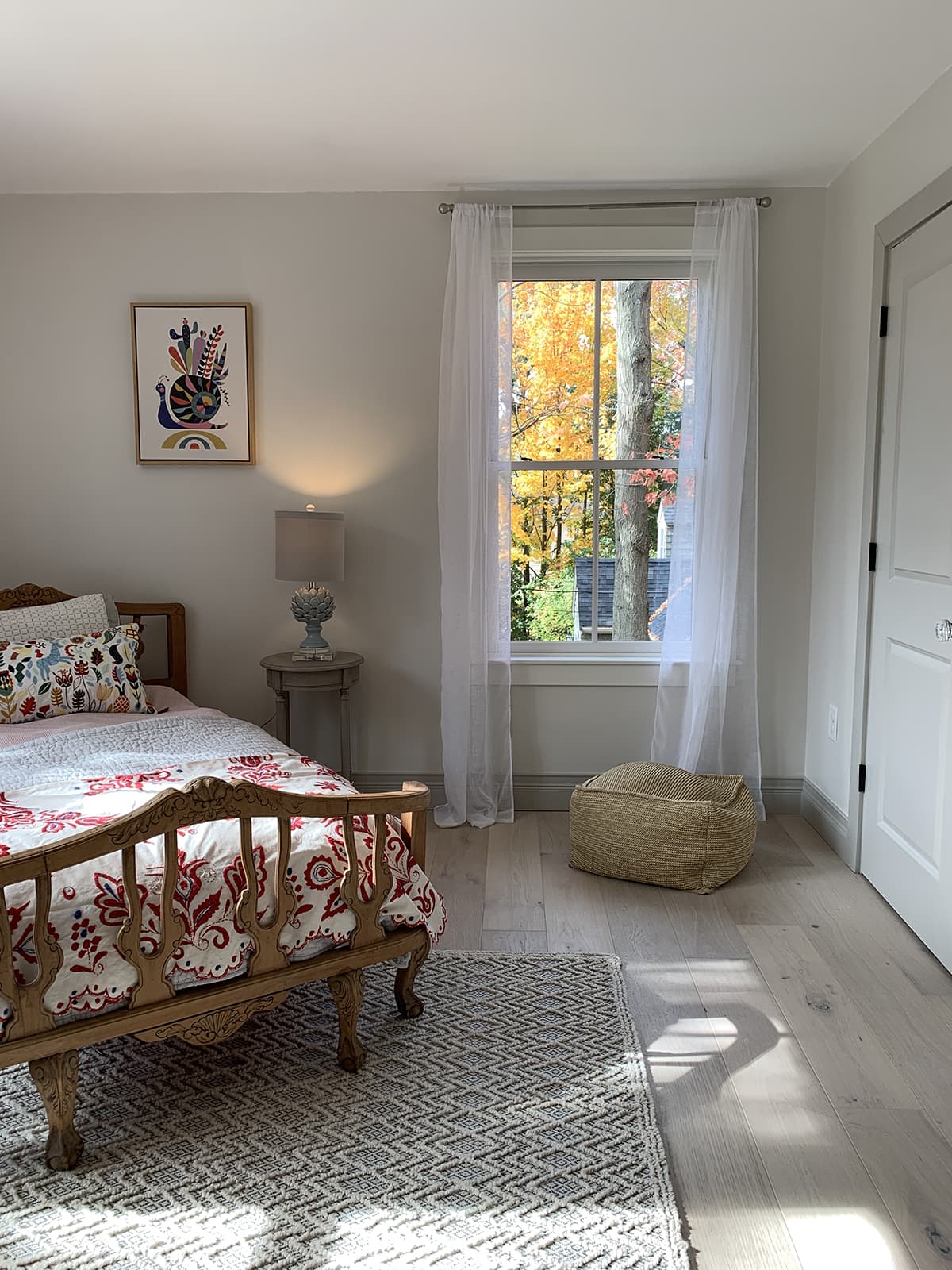 bedroom with darker baseboards and white window trim