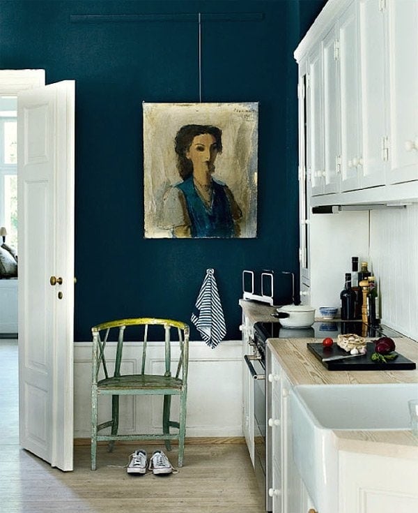 a kitchen with dark navy painted walls