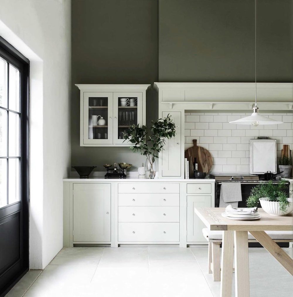 a kitchen with forest green painted walls