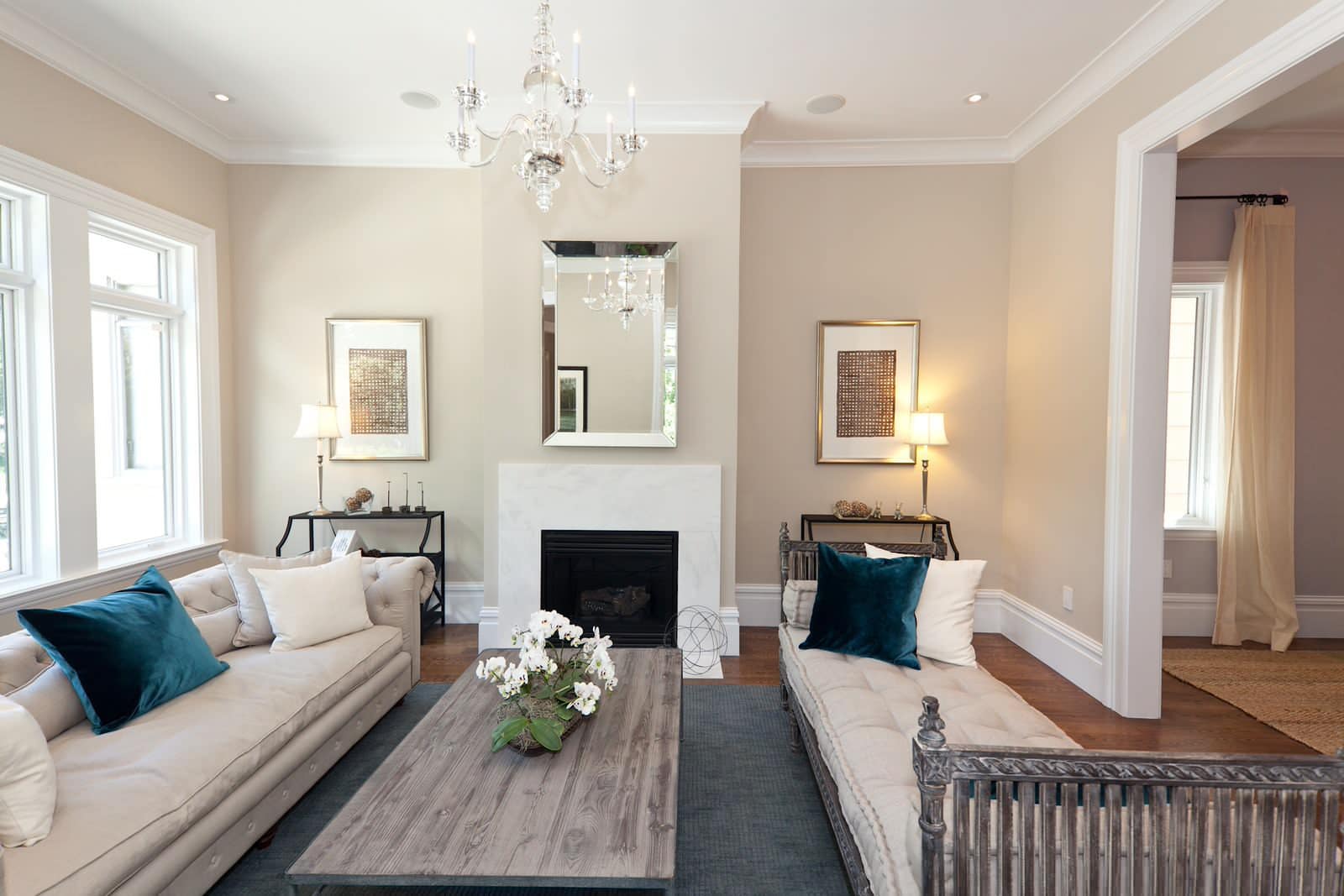 A living room filled with furniture and a fireplace with Benjamin Moore Edgecomb Gray paint color on the walls.