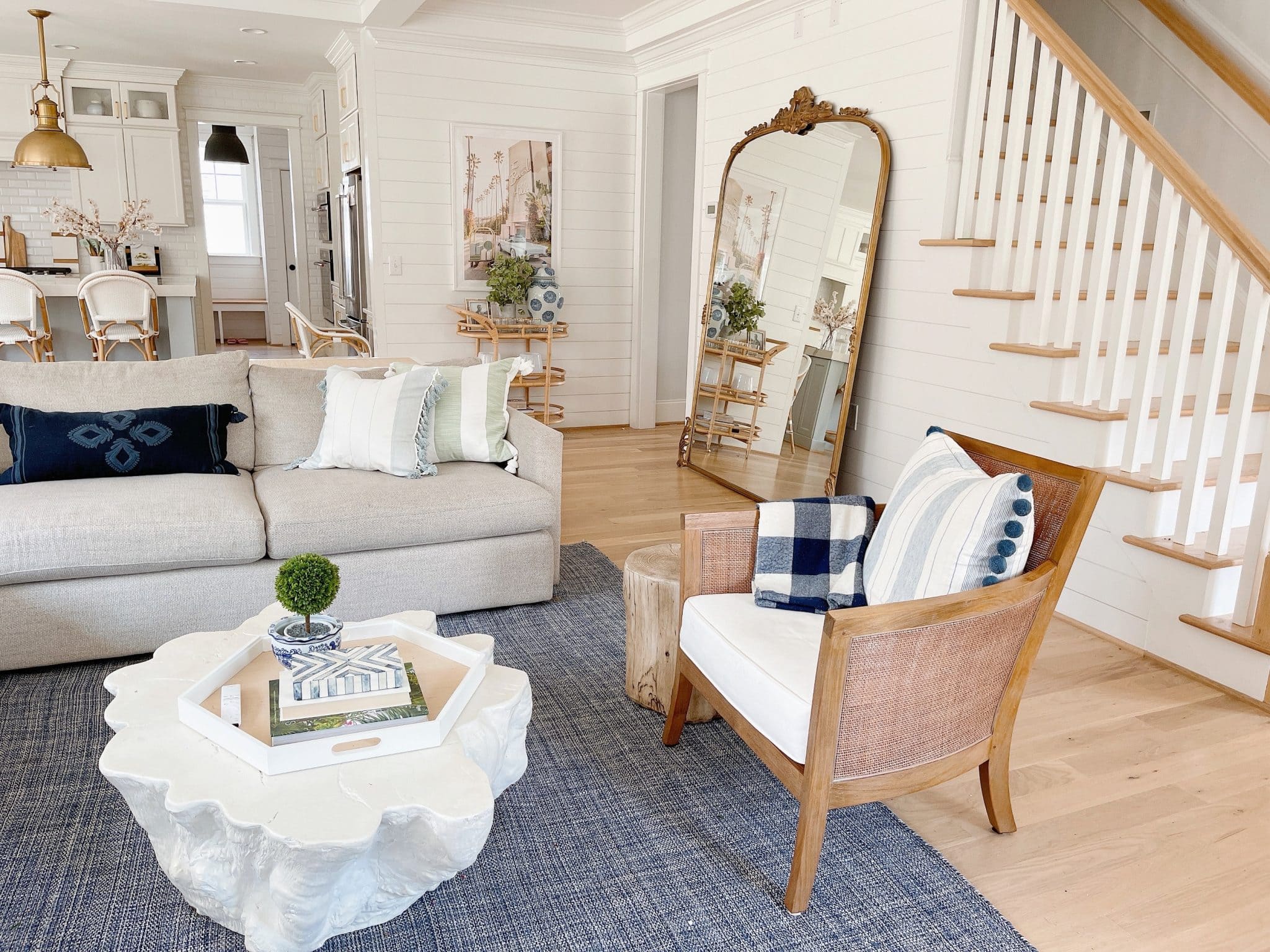 large floor mirror fills up an empty wall in a living room