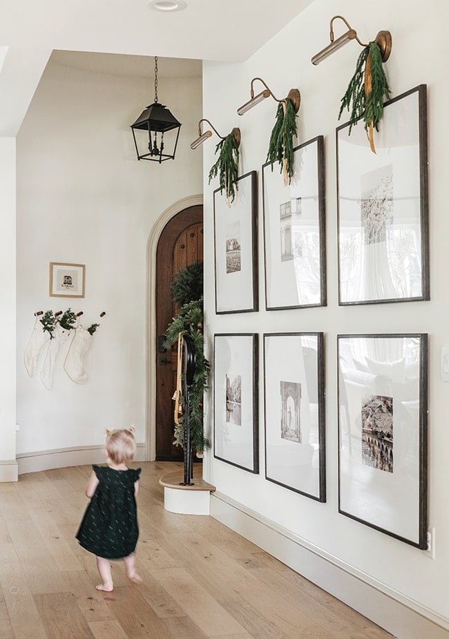 large wall with black and white family photos.