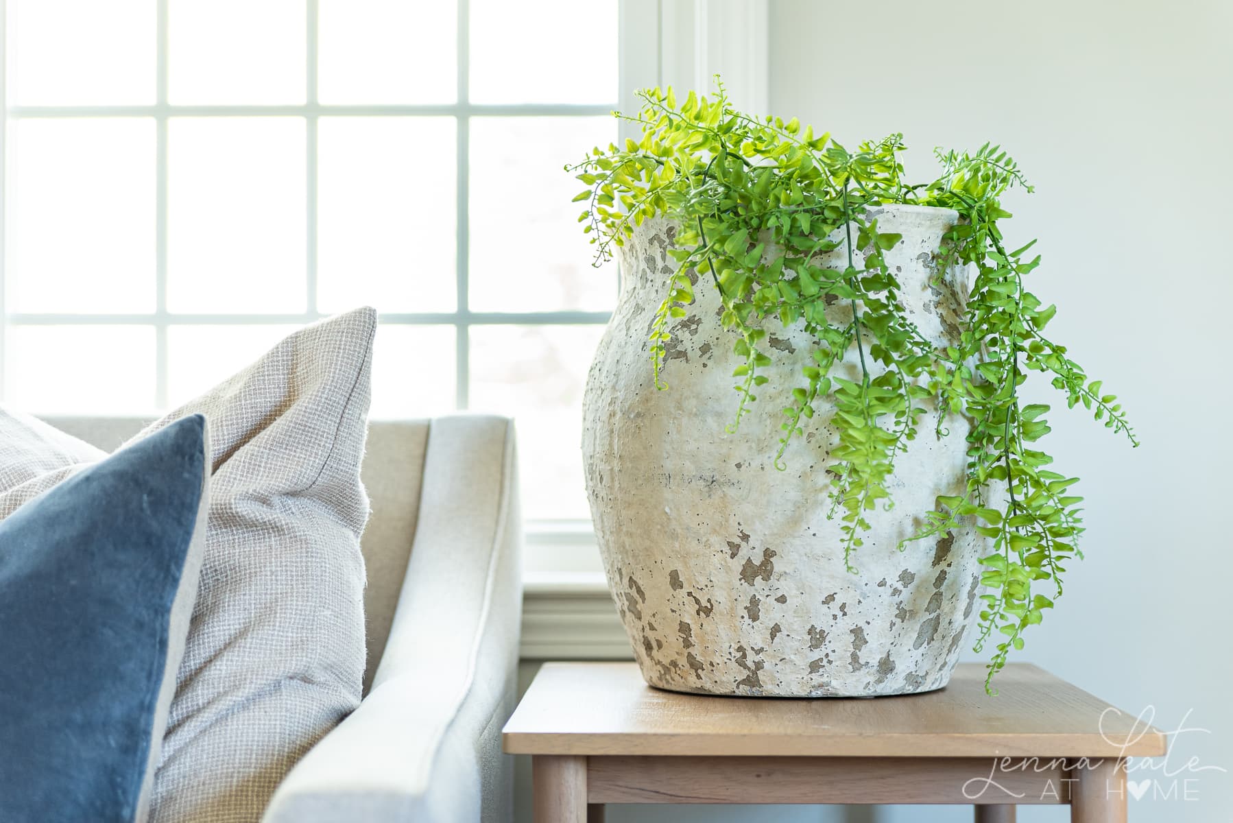 large urn with greenery spilling over the sides