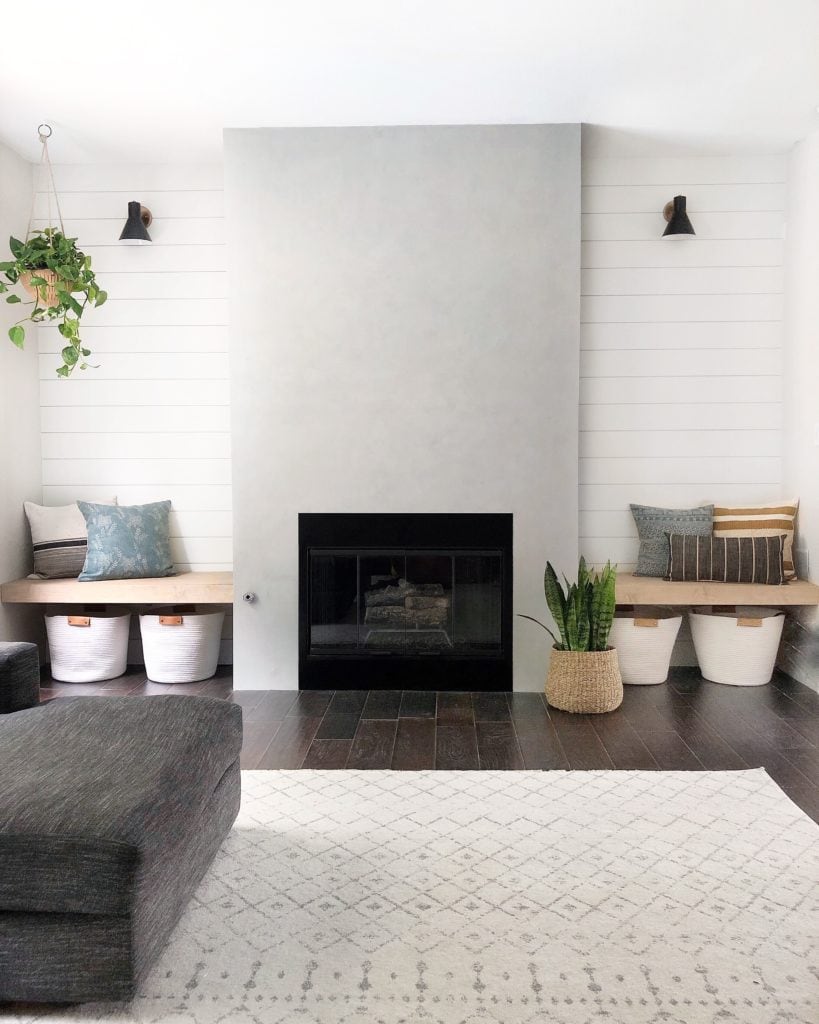 concrete fireplace with shiplap accent wall