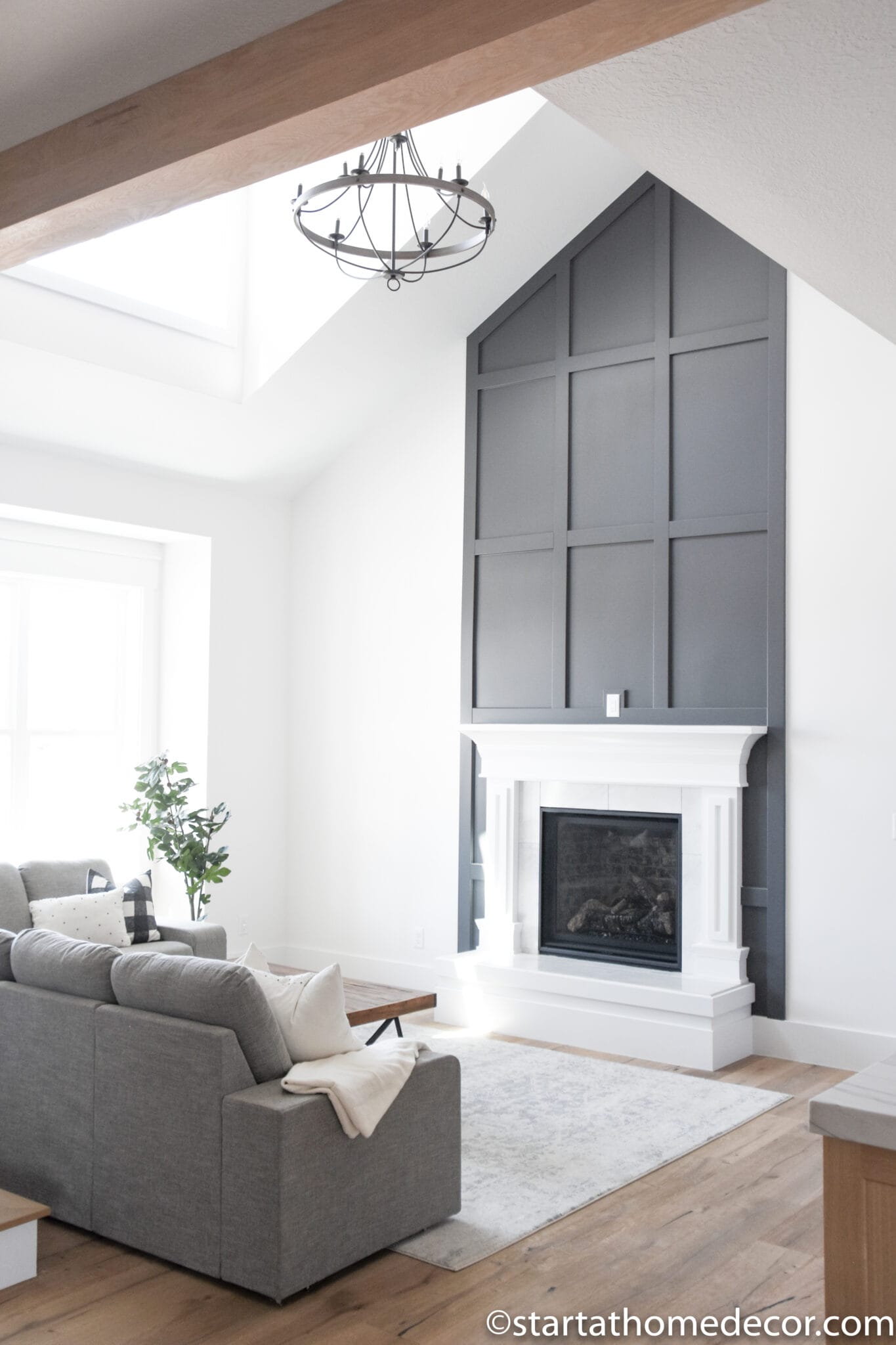 tall geometric millwork behind white fireplace