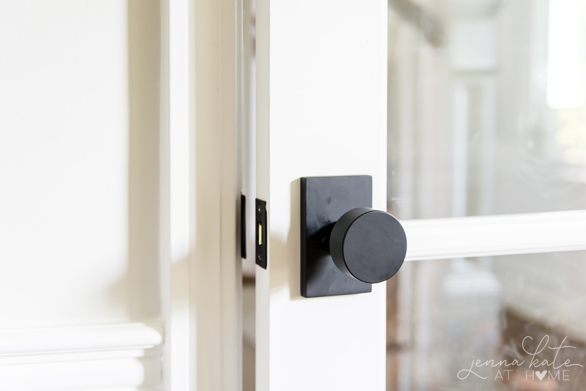 white door with a round black door handle