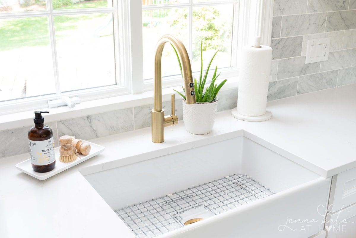 brass faucet and fireclay kitchen sink