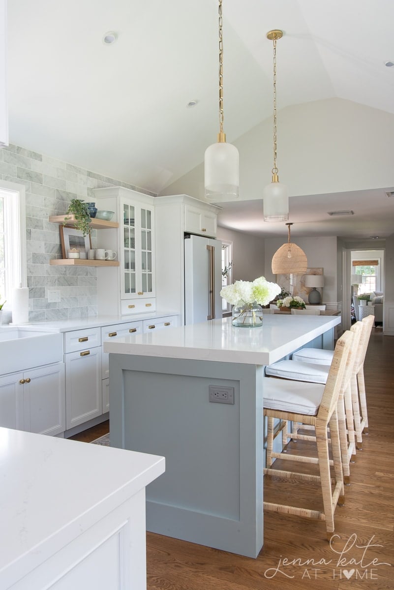 white kitchen with blue gray island