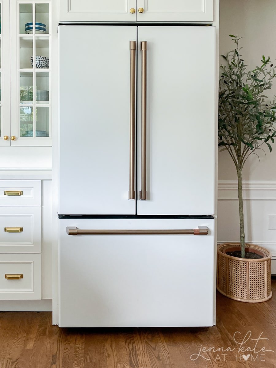 Matte white GE cafe appliances fridge with gold handles