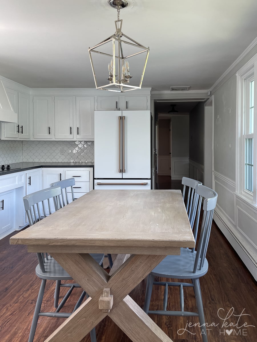 old kitchen with wooden dining table and gray chairs