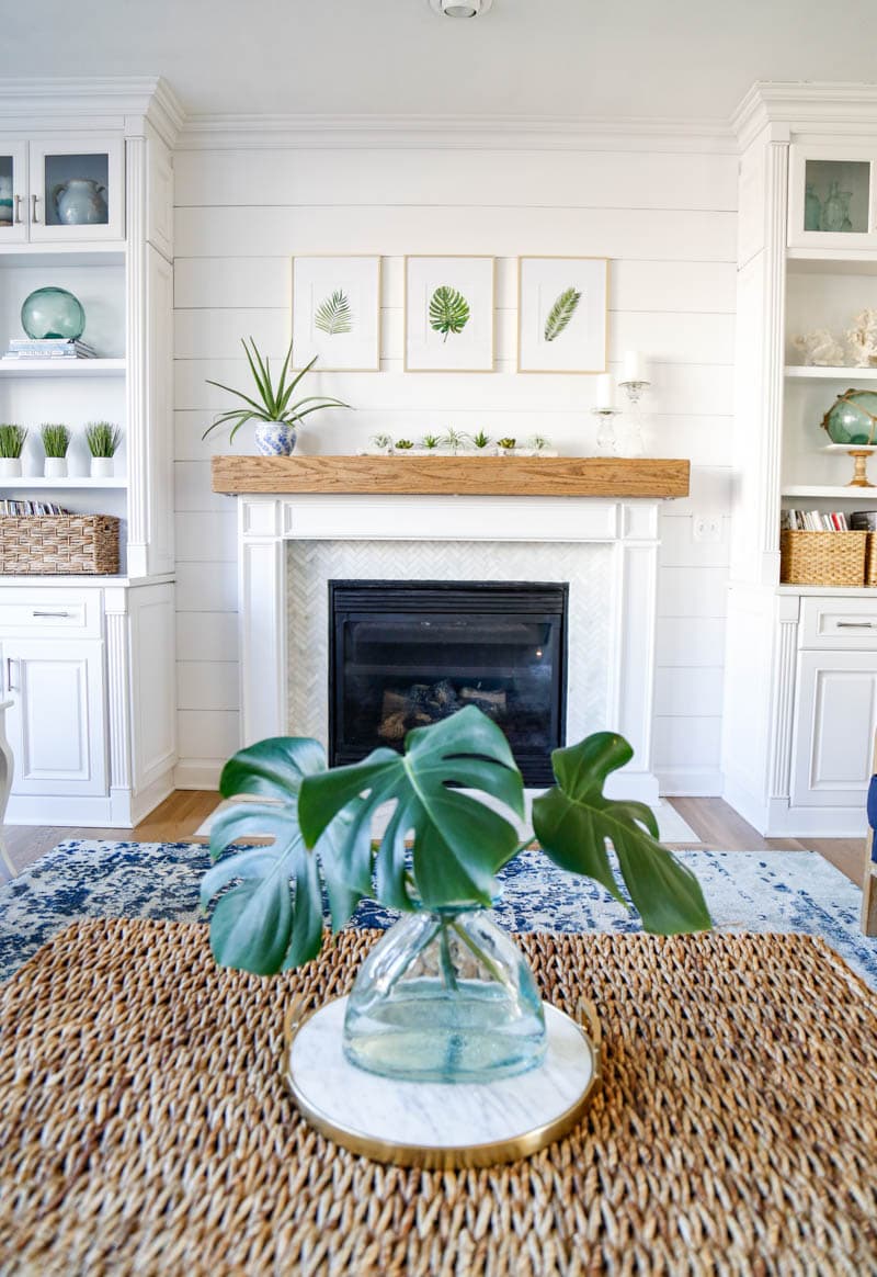 fireplace with white shiplap behind it