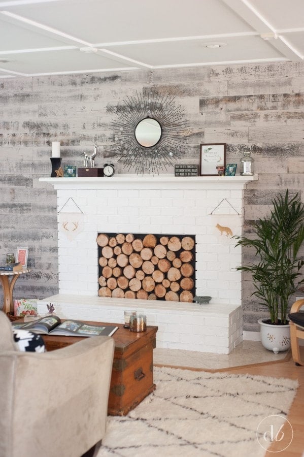 white brick fireplace with rustic reclaimed wood accent wall